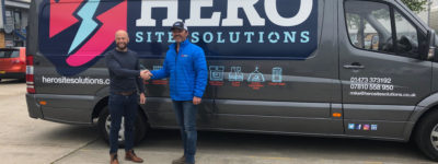 Mike shaking hands in front of Hero van
